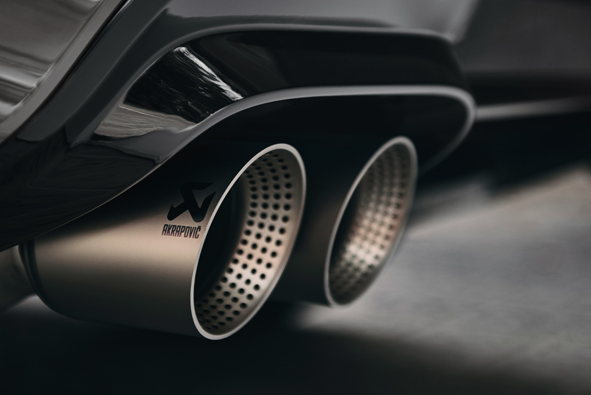 Close-up of the CUPRA Ateca's high-performance Akrapovič quad exhaust system, enhancing performance and sound.